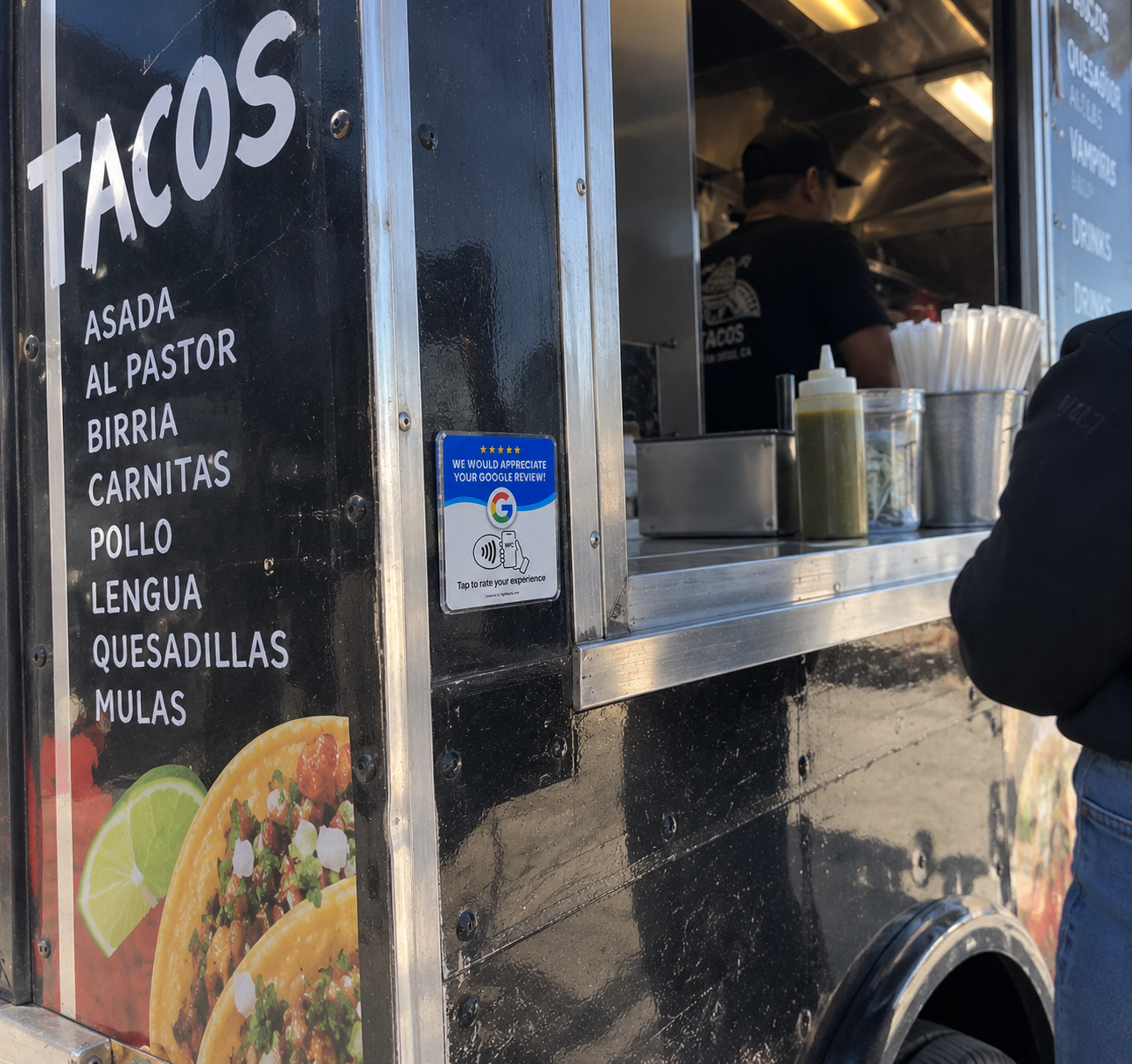 Google review plaque installed near a food truck service window